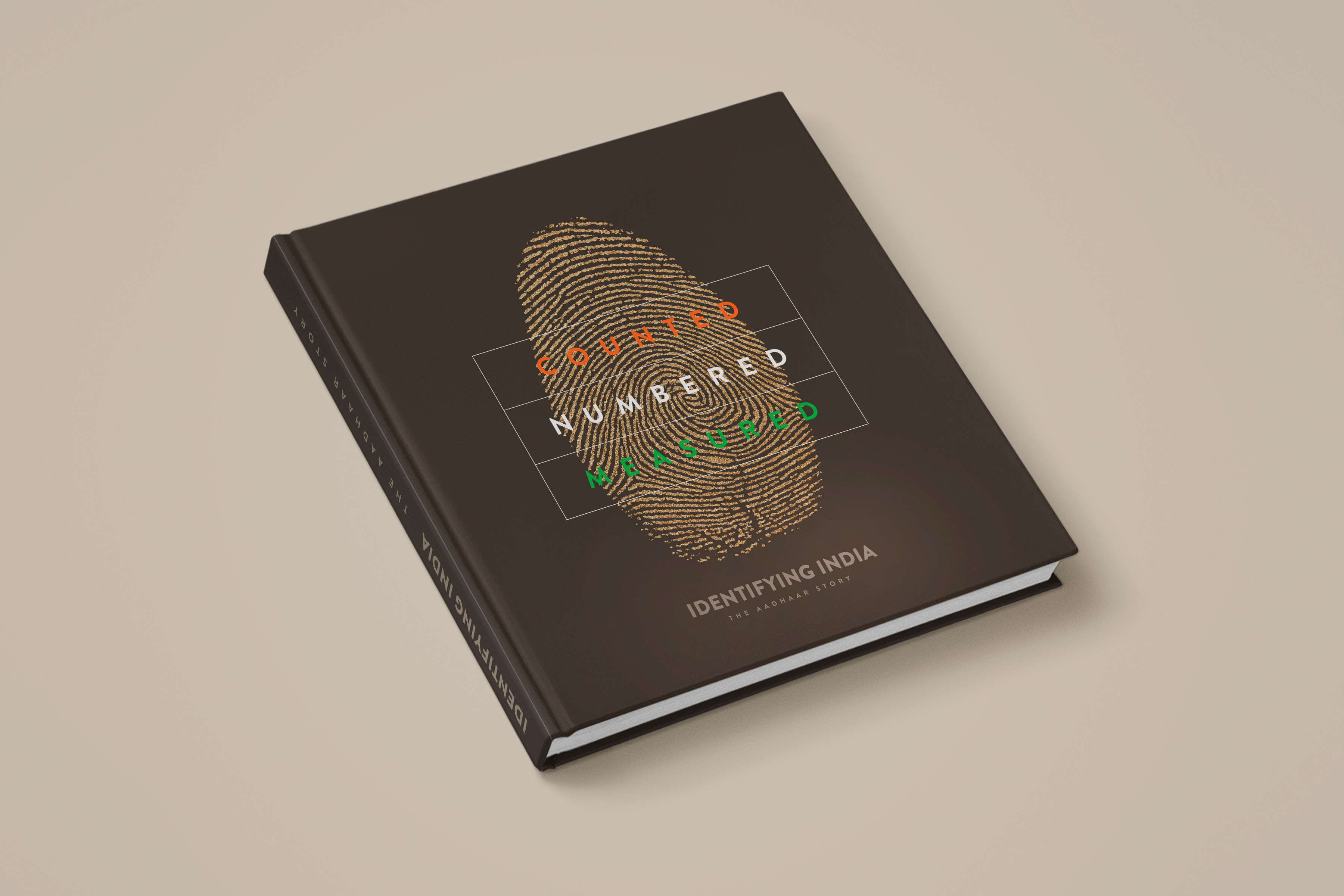 The closed Aadhaar book with a fingerprint illustration on its dark cover