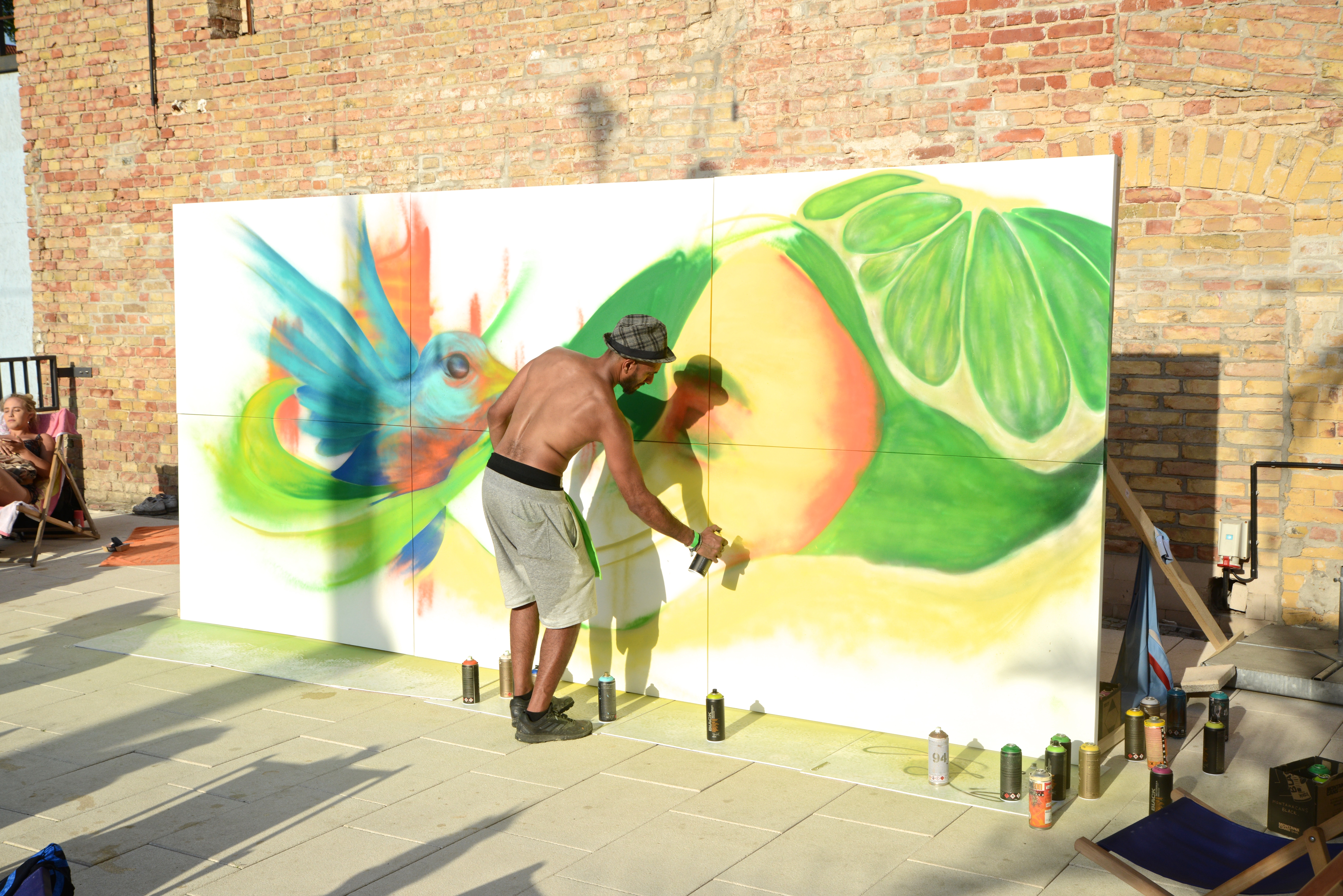 A live artist painting a colourful mural at the First Ride event