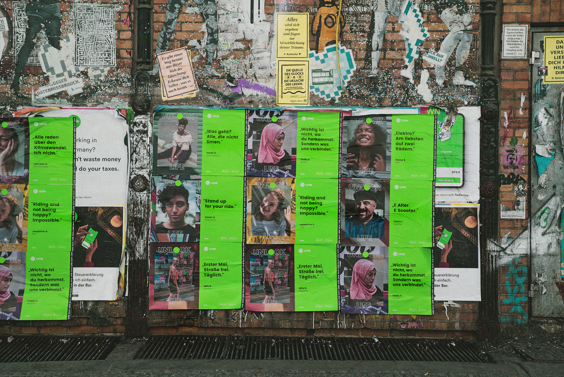 A wall covered in dozens of Unlock Life wild-posted posters